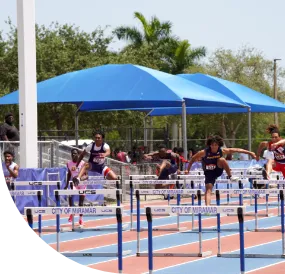 Team of athletes smiling throwing up the peace sign.