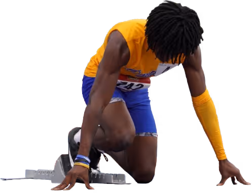 Track runner kneeling at blocks.