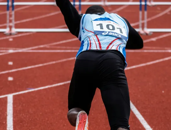 Track runner sprinting off the block